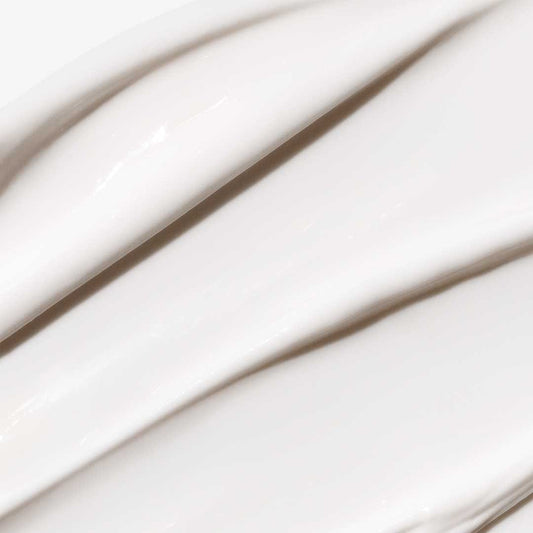 Nahaufnahme der glatten, glänzenden weißen Feuchtigkeitscreme von Intensive Moisture Balance, die in dicken, gewellten Linien aufgetragen wird - perfekt zur Vorbeugung von Feuchtigkeitsverlust und angereichert mit BioReplenish Complex.