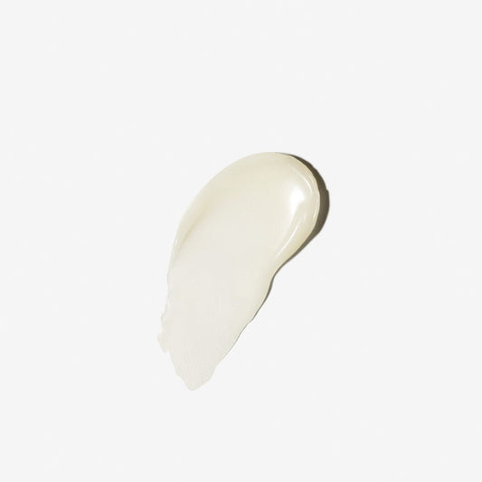 Eine kleine Menge der cremefarbenen Sound Sleep Cocoon | Nachtpflege-Creme oder -Lotion, die speziell für die transformative Nachtpflege entwickelt wurde, wird auf einem schlichten weißen Untergrund verteilt.